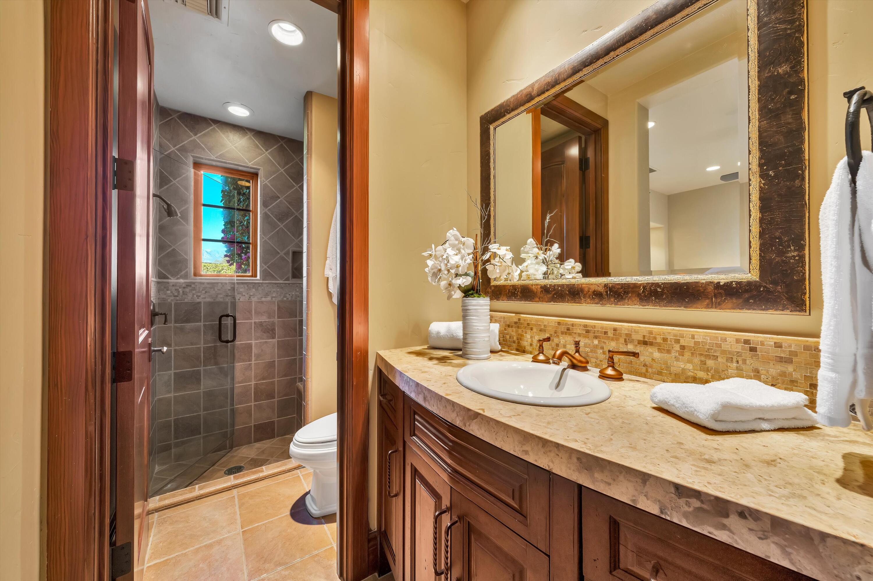 2 Serrano Way Rancho Mirage, CA 92270 - Photo 62 of 76 a bathroom with a granite countertop sink and a mirror