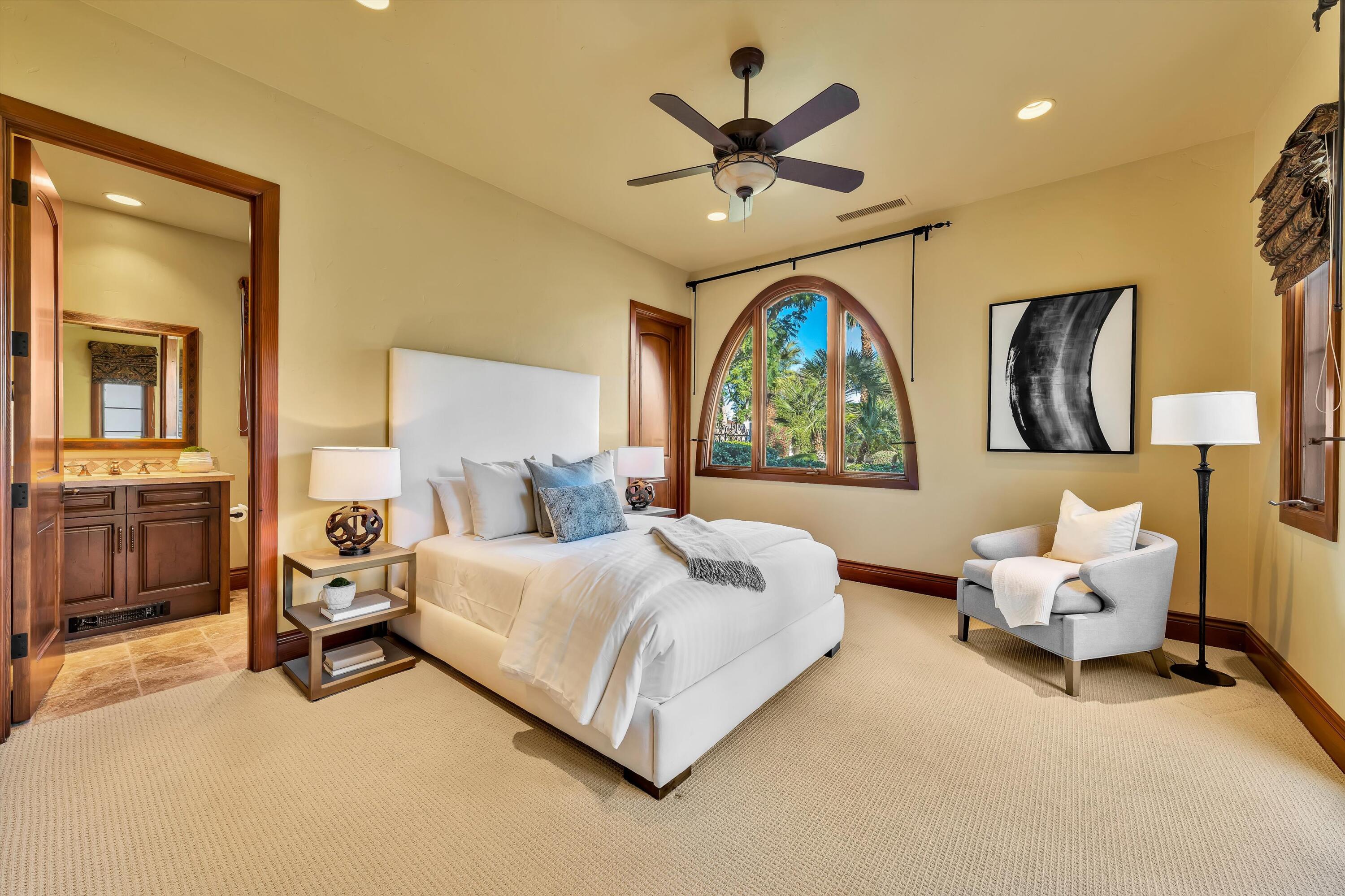 2 Serrano Way Rancho Mirage, CA 92270 - Photo 63 of 76 a spacious bedroom with a bed window and couch