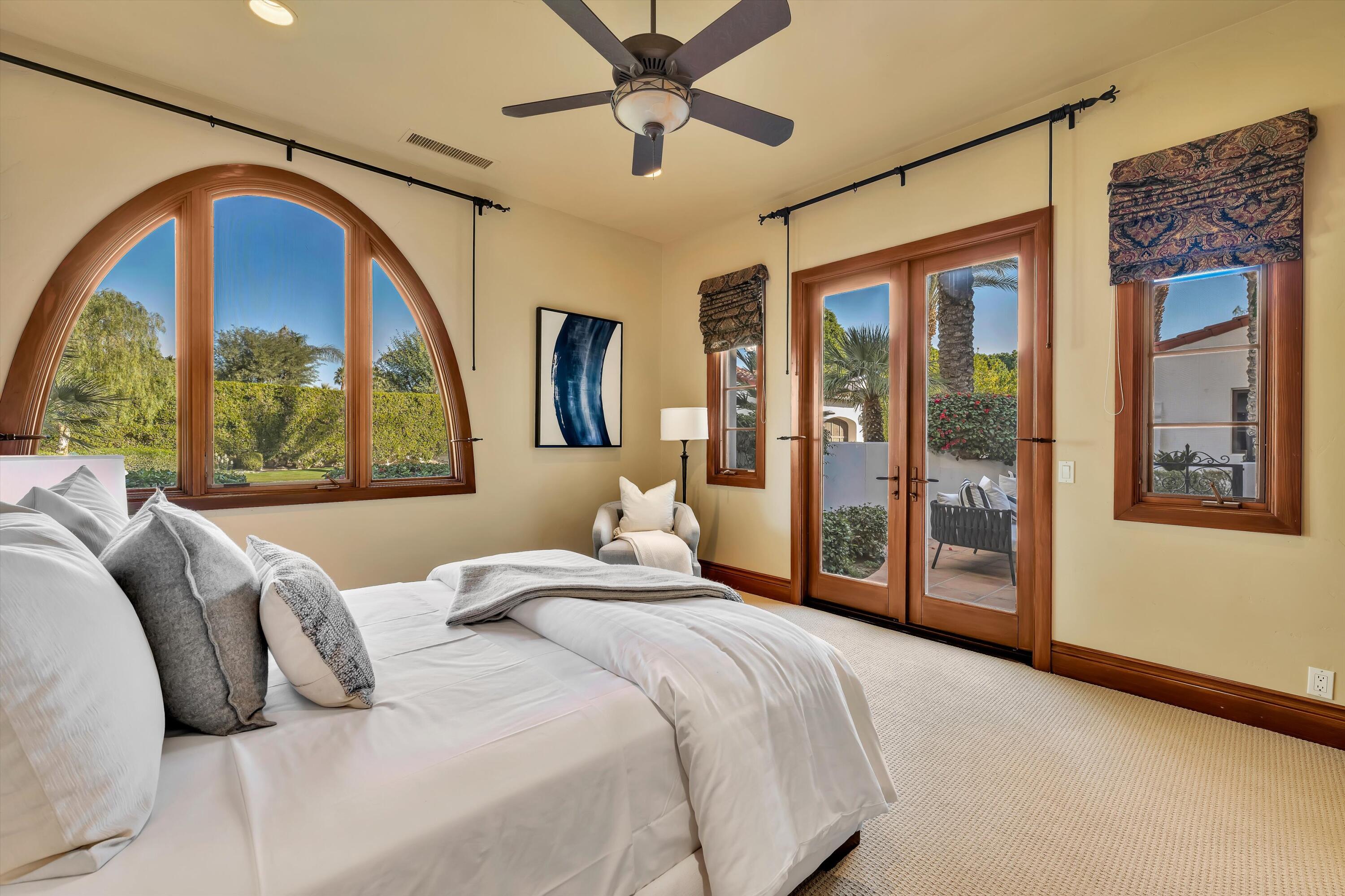 2 Serrano Way Rancho Mirage, CA 92270 - Photo 64 of 76 a bedroom with a large bed and a large window