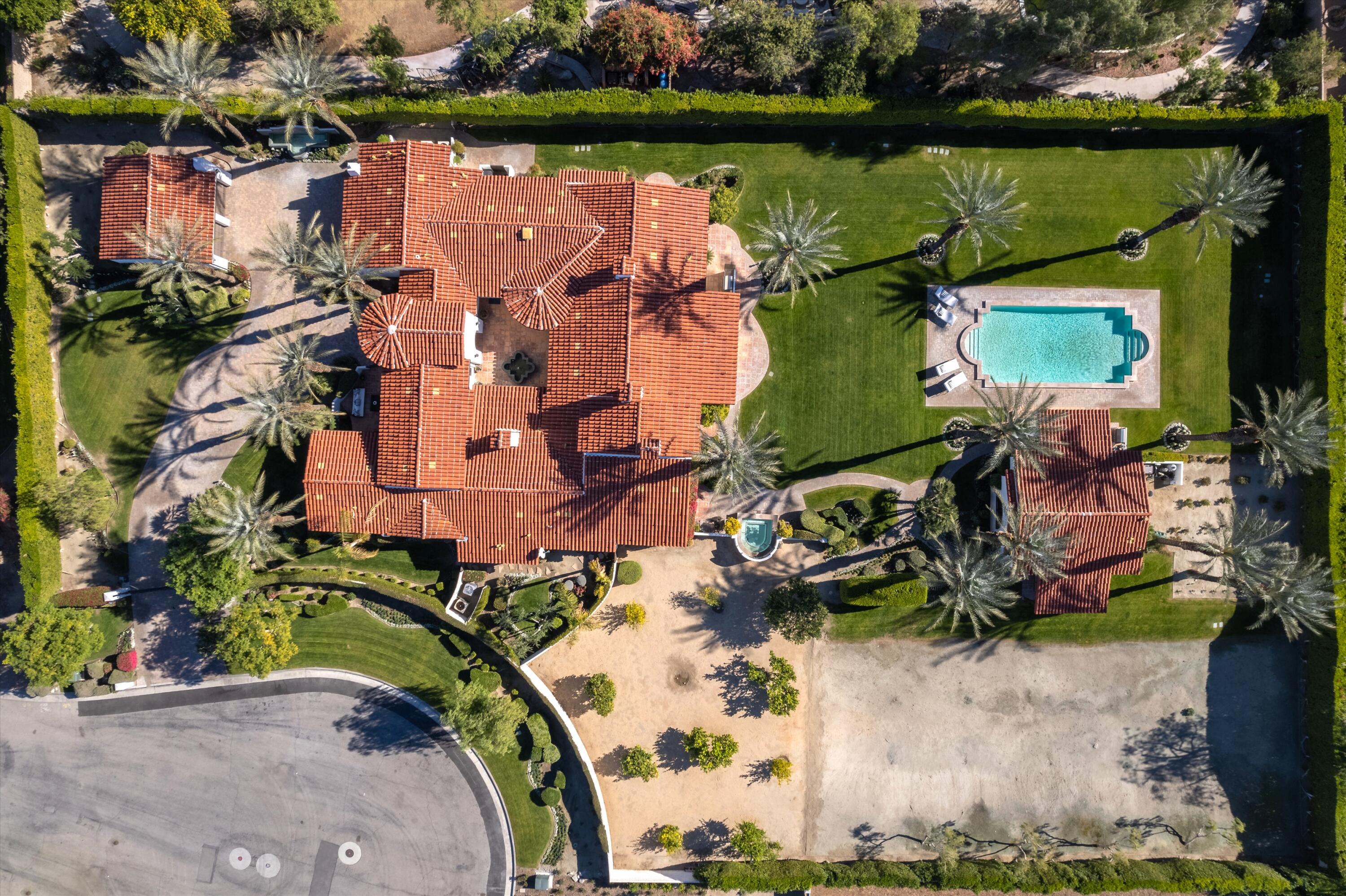 2 Serrano Way Rancho Mirage, CA 92270 - Photo 7 of 76 an aerial view of a house with a lake and a yard