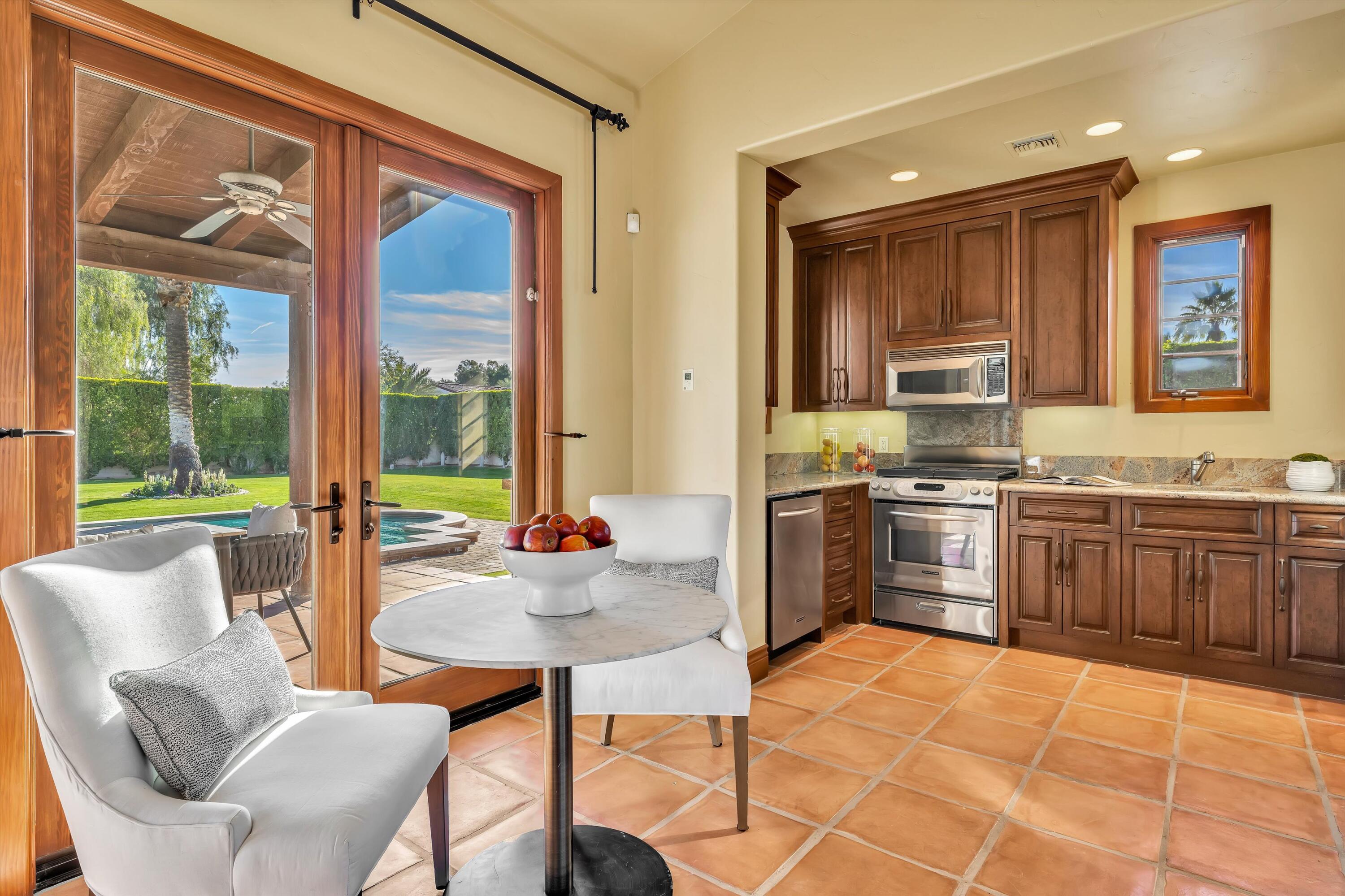 2 Serrano Way Rancho Mirage, CA 92270 - Photo 74 of 76 a kitchen with a stove a sink and a refrigerator