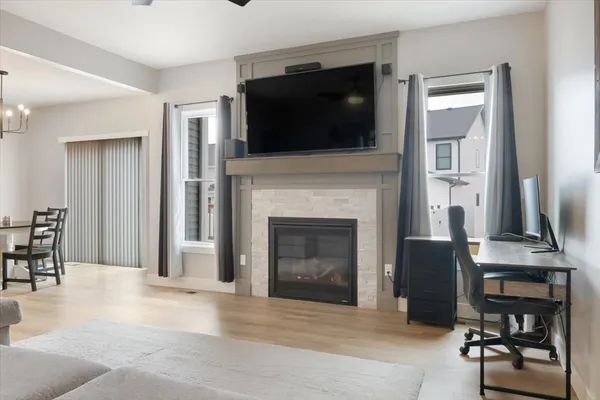 a living room with furniture a flat screen tv and a fireplace