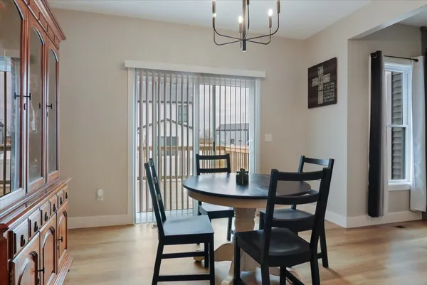 a view of a dining room with furniture wooden floor and chandelier