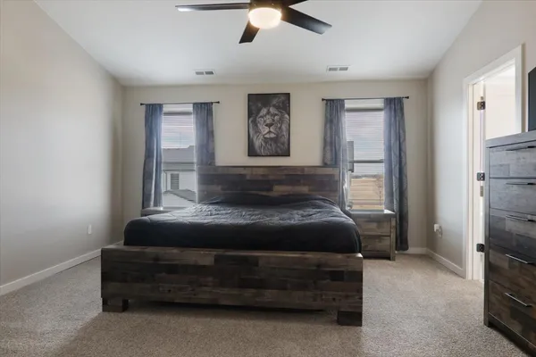 a bedroom with a bed and a chandelier