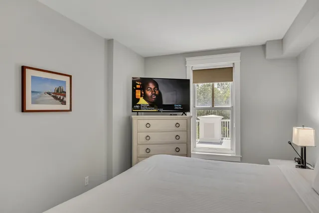 a bedroom with a bed and flat screen tv