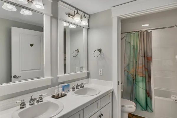 a bathroom with a sink double vanity and a mirror