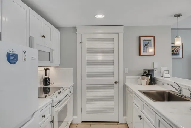 a kitchen with cabinets stainless steel appliances and a sink