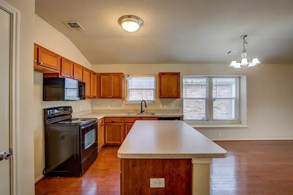 a kitchen with a sink stove and refrigerator
