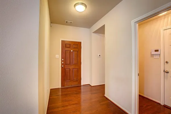 a view of a hallway with wooden floor