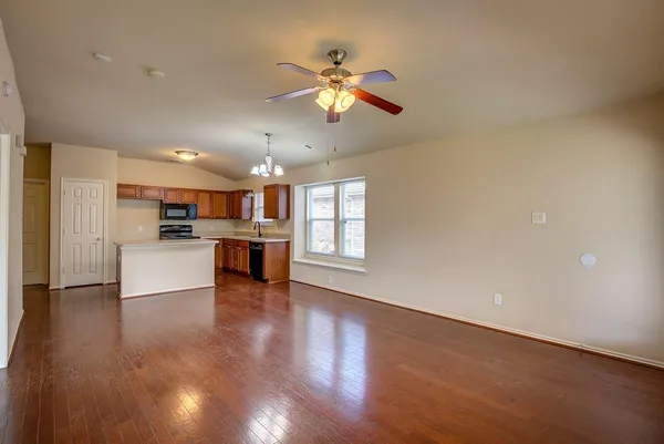 a view of kitchen with refrigerator and window