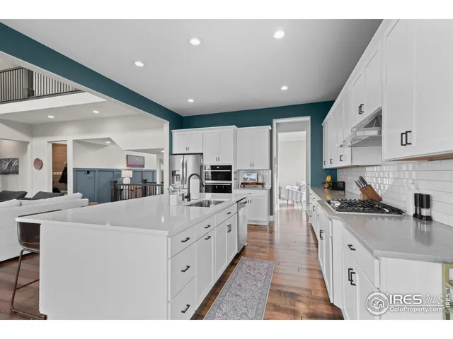 a large white kitchen with cabinets