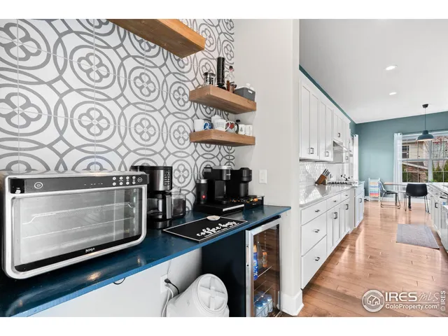 a kitchen with stainless steel appliances kitchen island granite countertop a stove and a microwave