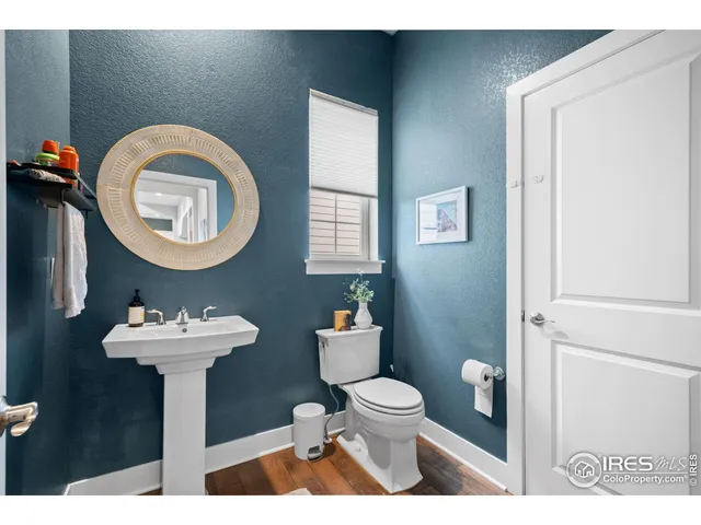 a bathroom with a sink mirror and toilet