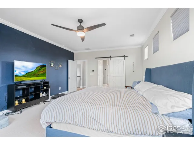 a bedroom with a bed and a tv