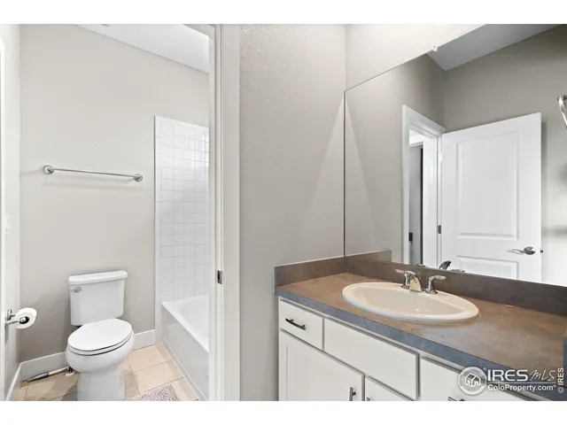 a bathroom with a sink toilet a mirror and vanity