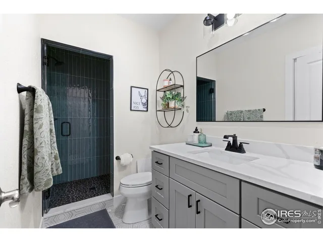 a bathroom with a toilet a sink and a mirror