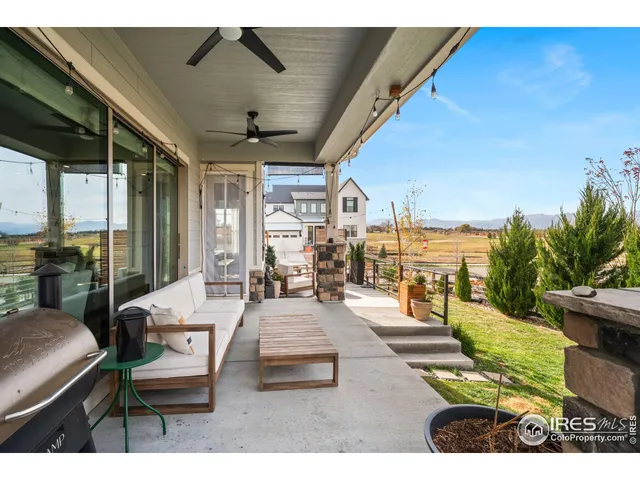 a living room with patio furniture and a floor to ceiling window