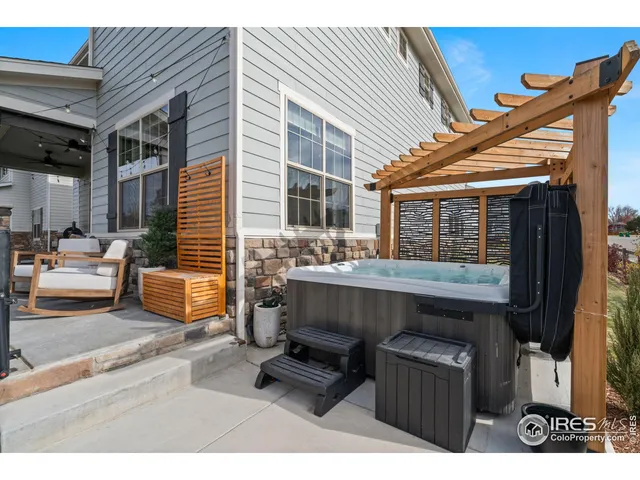 a view of backyard with a table and chairs and potted plants