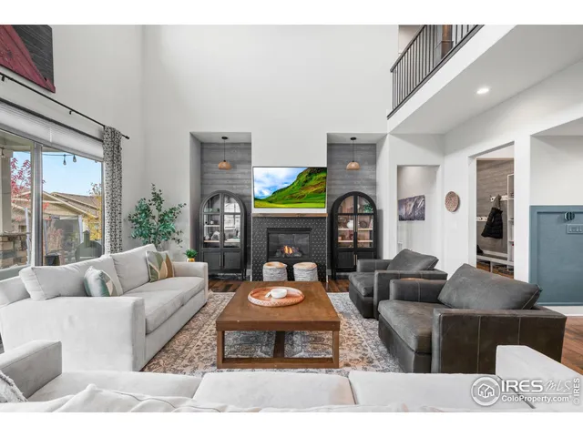 a living room with furniture a rug and a fireplace