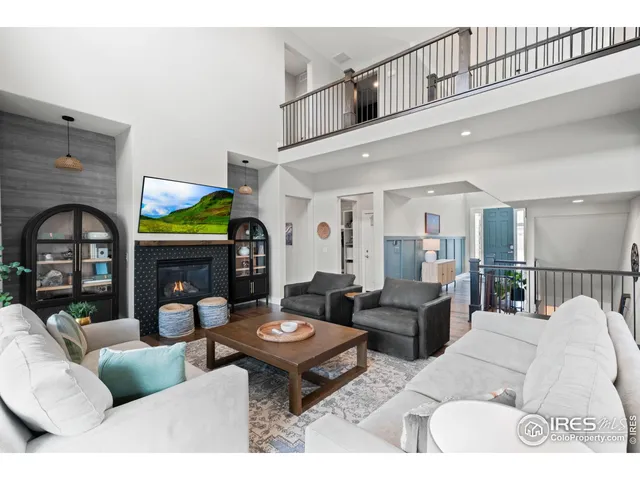 a living room with fireplace furniture and a fireplace