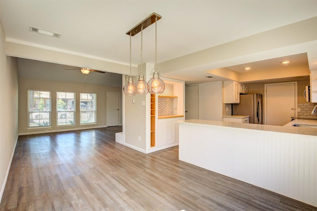 3728 Blue Bonnet Court Flower Mound, TX 75028 - Photo 14 of 40 a large kitchen with sink a refrigerator and wooden floor
