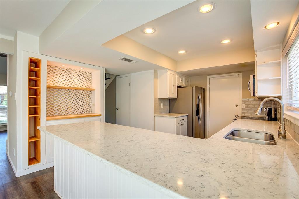 3728 Blue Bonnet Court Flower Mound, TX 75028 - Photo 16 of 40 a kitchen with stainless steel appliances kitchen island granite countertop a refrigerator and a sink