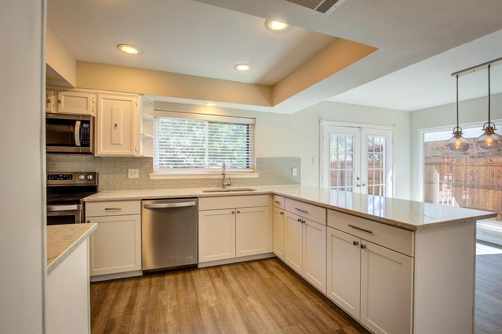 3728 Blue Bonnet Court Flower Mound, TX 75028 - Photo 19 of 40 a large kitchen with stainless steel appliances granite countertop a stove and a sink