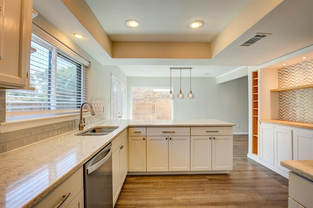 3728 Blue Bonnet Court Flower Mound, TX 75028 - Photo 20 of 40 a view of a kitchen counter top space a sink a window and stainless steel appliances