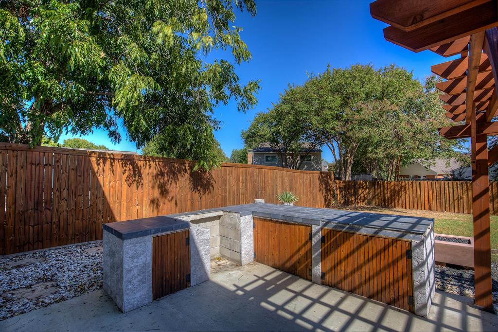3728 Blue Bonnet Court Flower Mound, TX 75028 - Photo 40 of 40 a view of a backyard with a bench