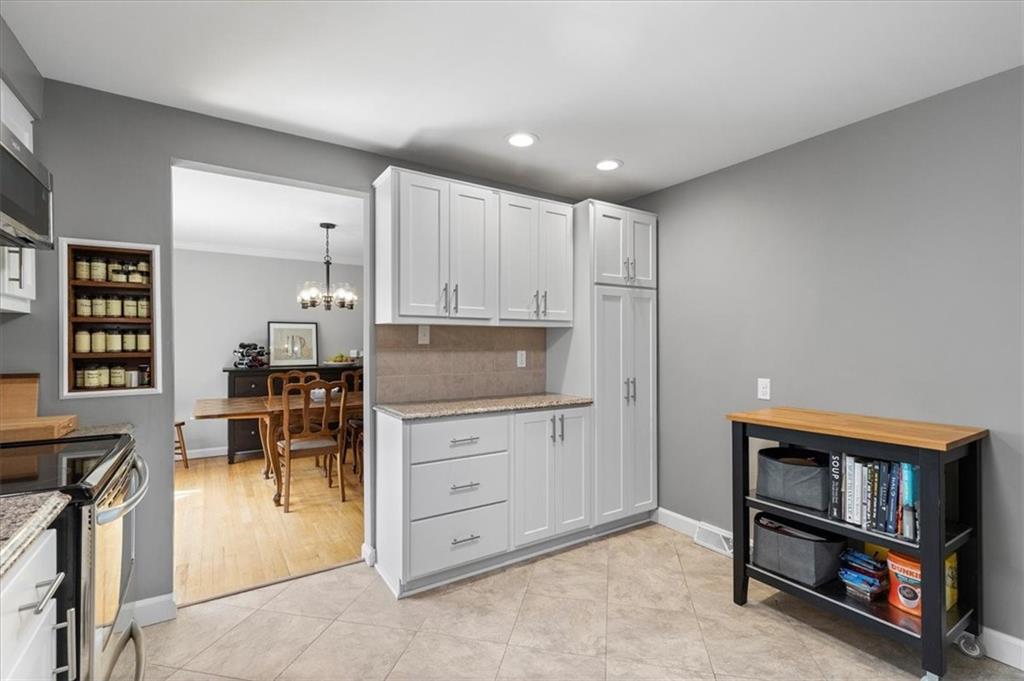 1220 Rolling Meadow Road Pittsburgh, PA 15241 - Photo 11 of 46 a kitchen with stainless steel appliances kitchen island granite countertop a refrigerator and cabinets