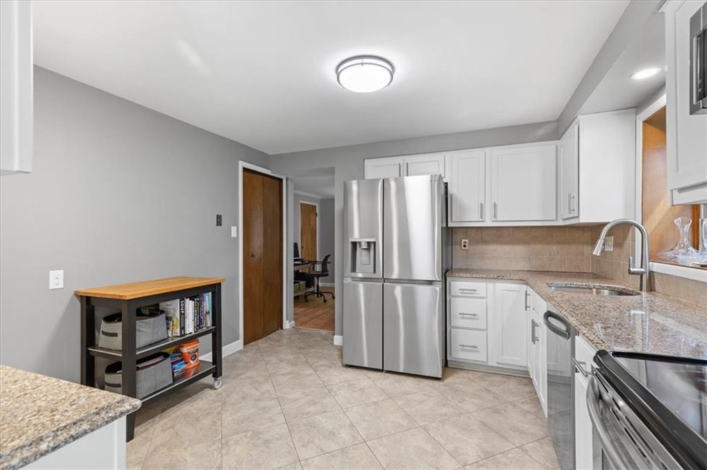 1220 Rolling Meadow Road Pittsburgh, PA 15241 - Photo 9 of 46 a kitchen with stainless steel appliances granite countertop a refrigerator and a stove top oven
