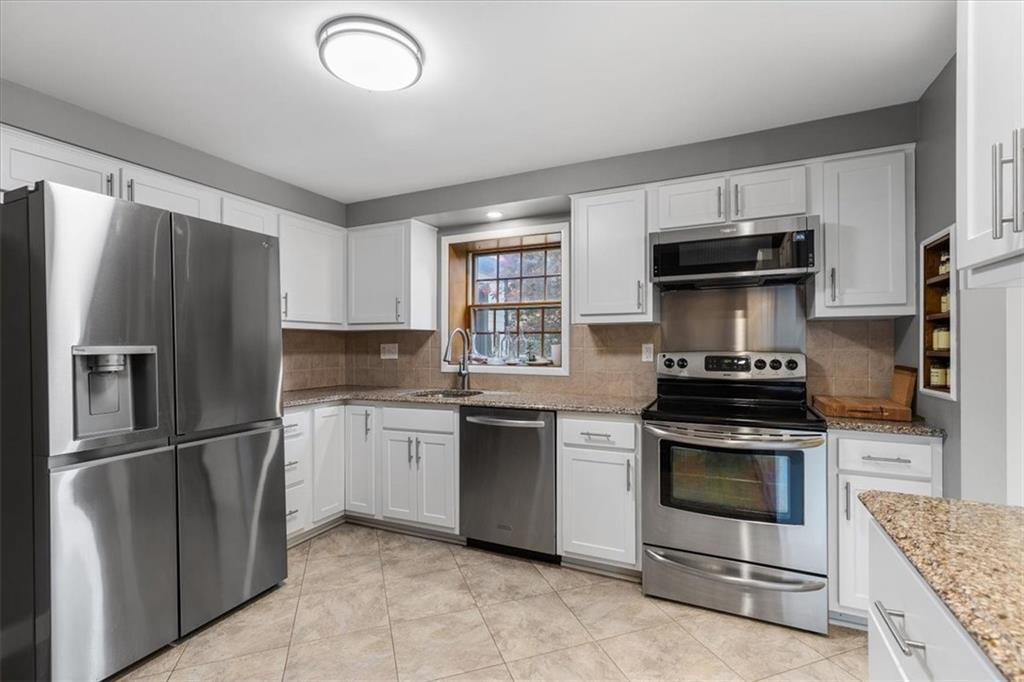 1220 Rolling Meadow Road Pittsburgh, PA 15241 - Photo 10 of 46 a kitchen with granite countertop stainless steel appliances and wooden cabinets