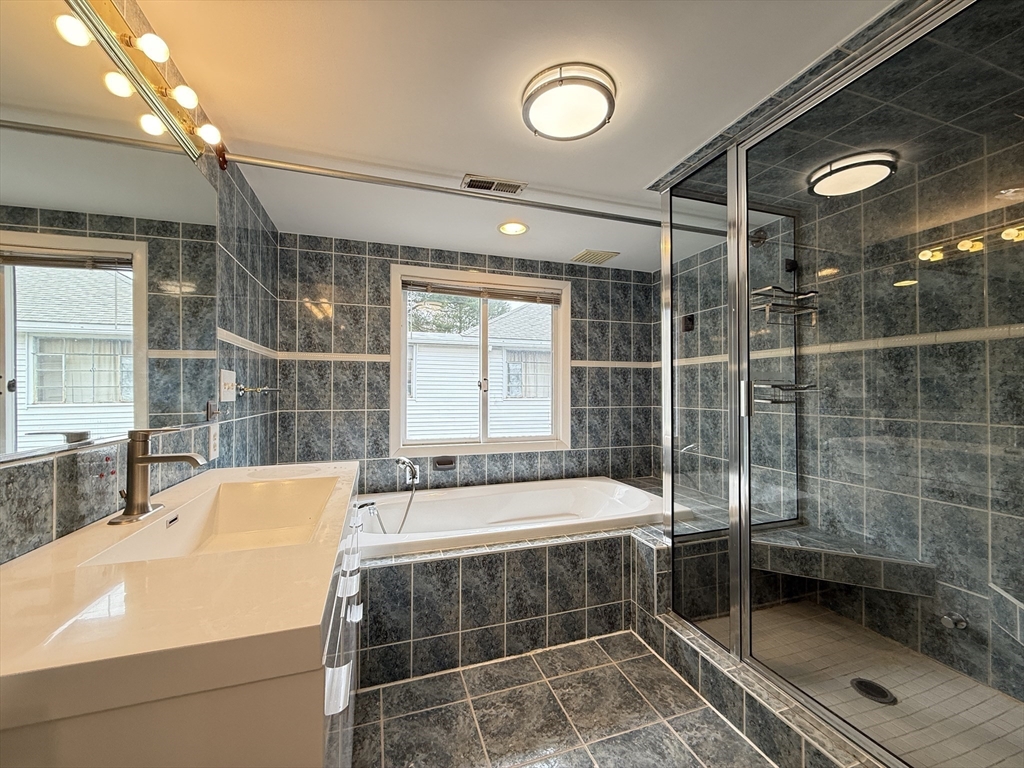 115 Grove Street Brookline, MA 02467 - Photo 6 of 12 a bathroom with a tub and a shower