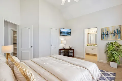 a bedroom with a bed and a couch