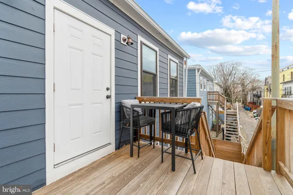 a patio with wooden floor and outdoor seating