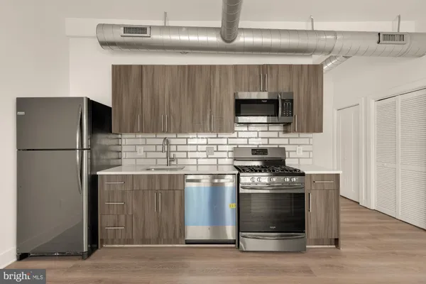 a kitchen with stainless steel appliances a stove and a refrigerator