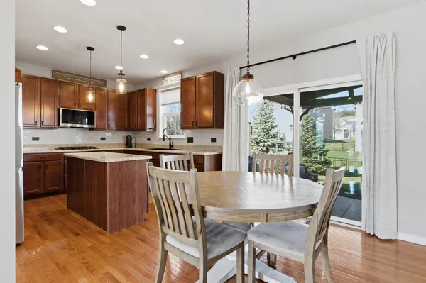 a kitchen with kitchen island a large counter space and stainless steel appliances