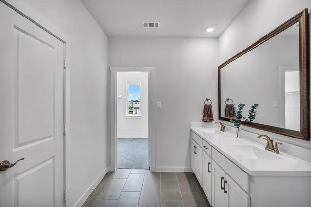 a bathroom with a double vanity sink and mirror