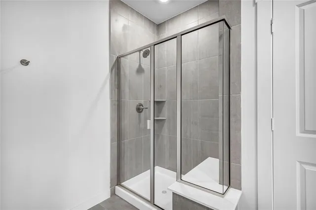 a bathroom with a glass shower door