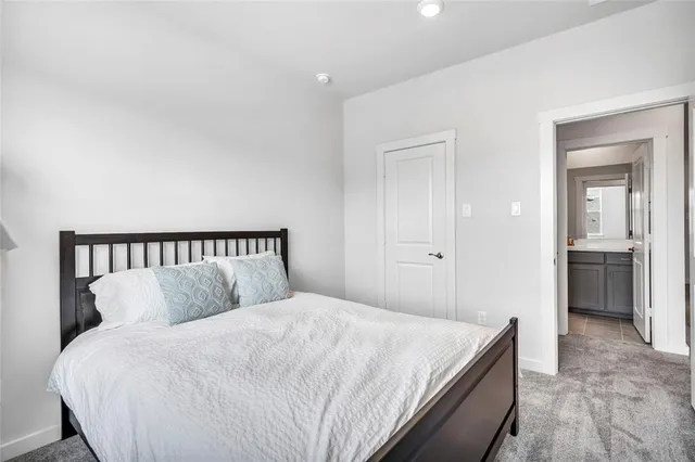 a large bed in a white room with closet