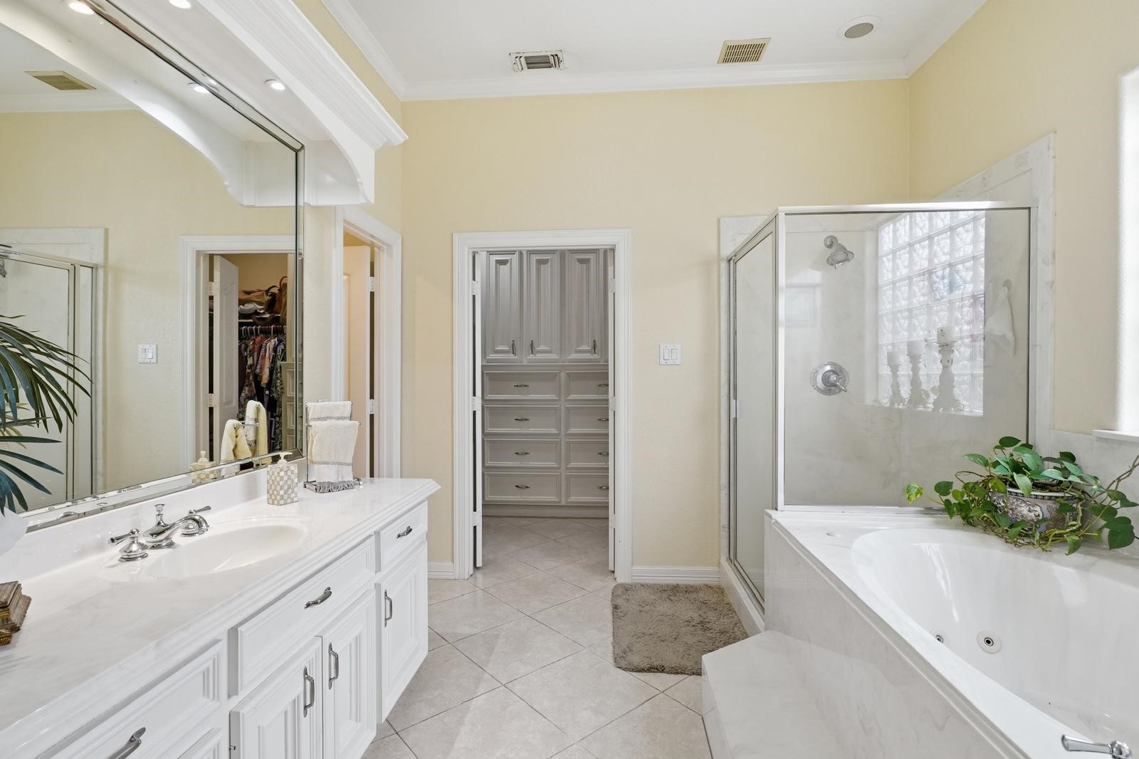 247 Old Spring Lane Houston, TX 77015 - Photo 14 of 25 a spacious bathroom with a double vanity sink a large mirror a bathtub and shower