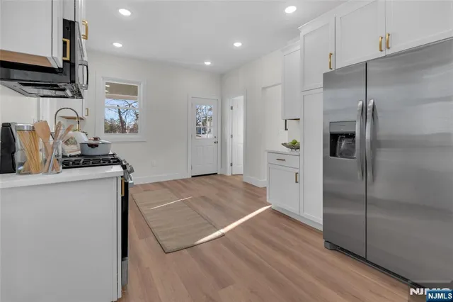 a kitchen with a refrigerator and a sink