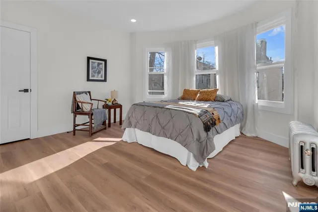 a bed sitting in a bedroom next to a window