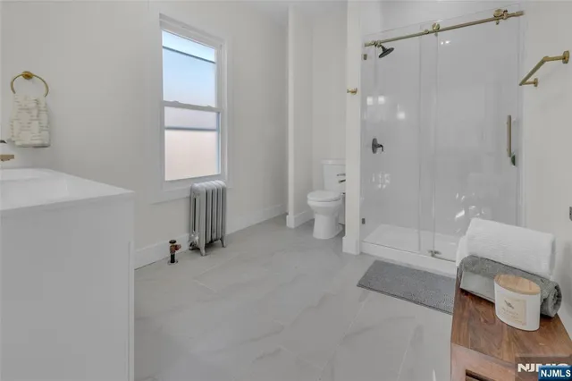 a spacious bathroom with a bathtub and a toilet