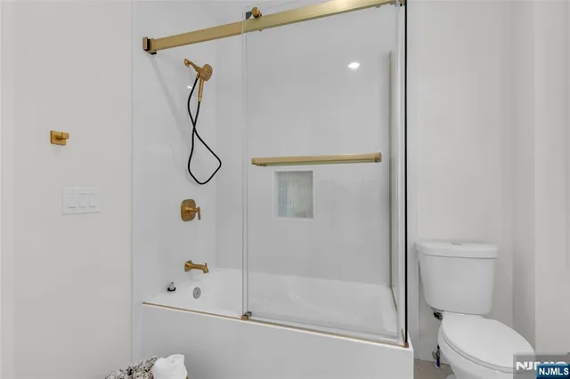 a bathroom with a shower and toilet
