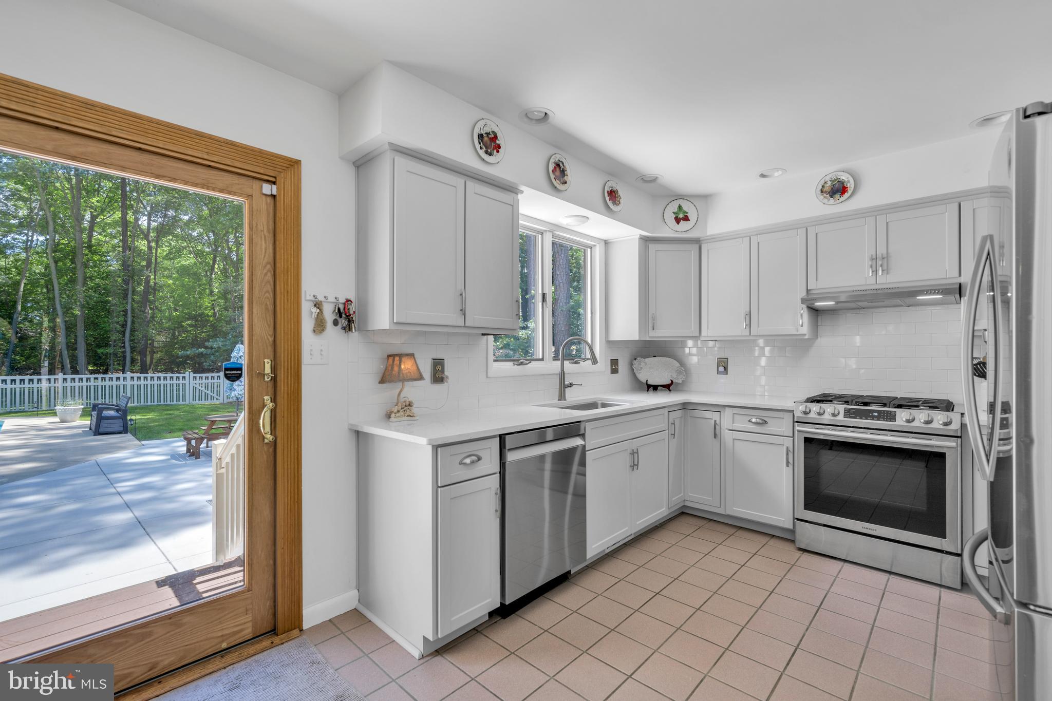 292 Pond Road Millsboro, DE 19966 - Photo 12 of 66 a kitchen with a stove sink and cabinets