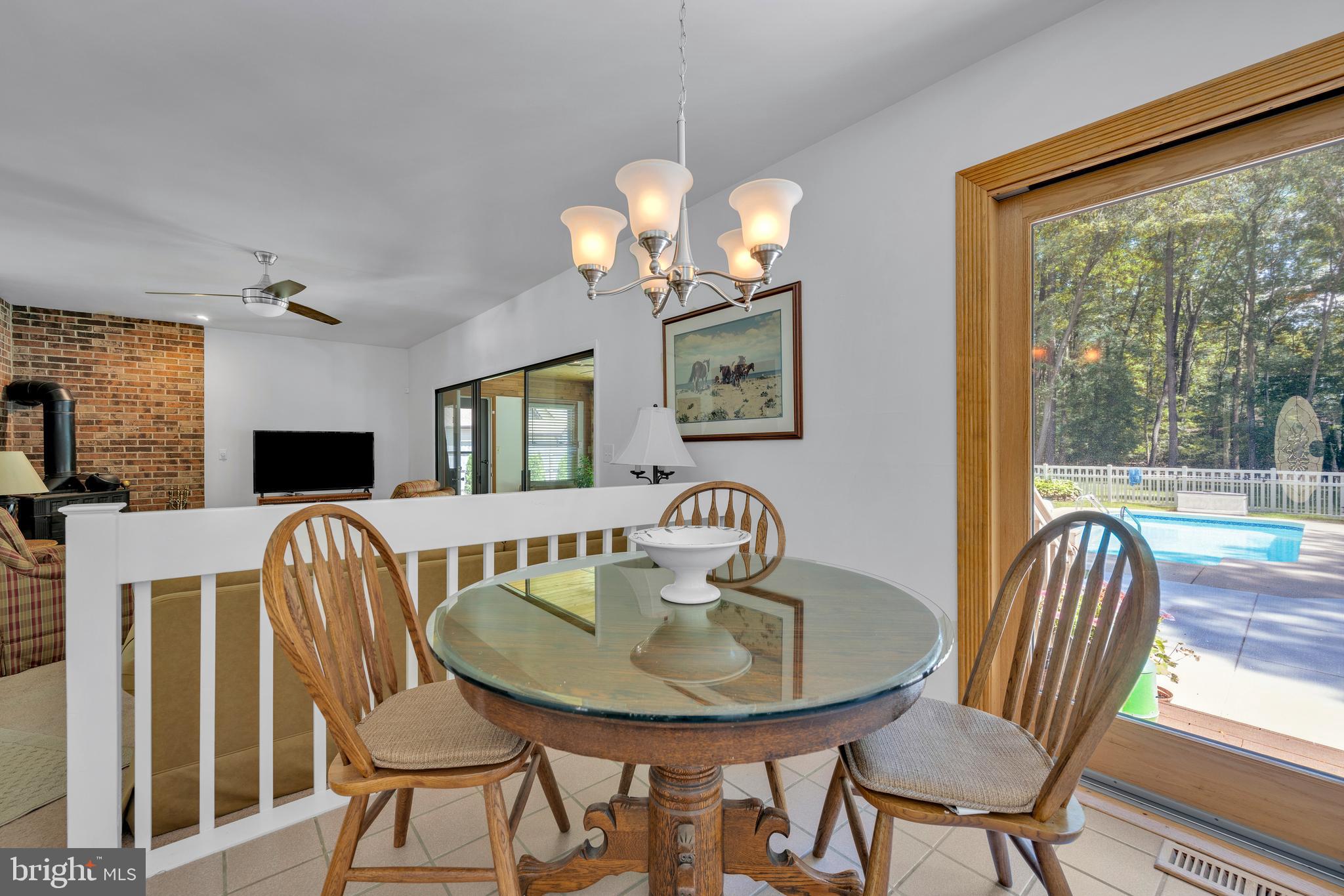 292 Pond Road Millsboro, DE 19966 - Photo 13 of 66 a view of a dining room with furniture window and outside view