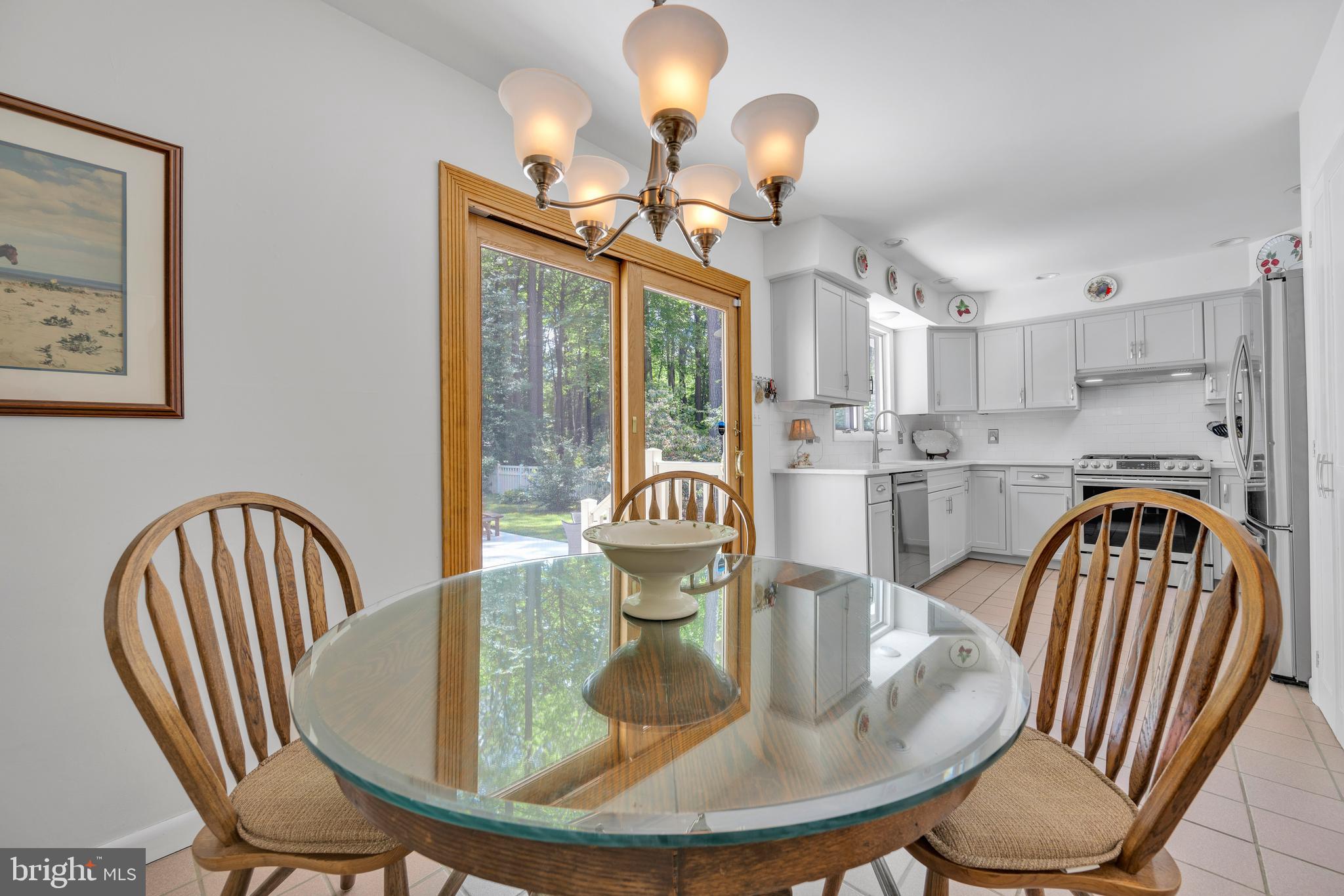 292 Pond Road Millsboro, DE 19966 - Photo 14 of 66 a dining room with furniture a chandelier and wooden floor