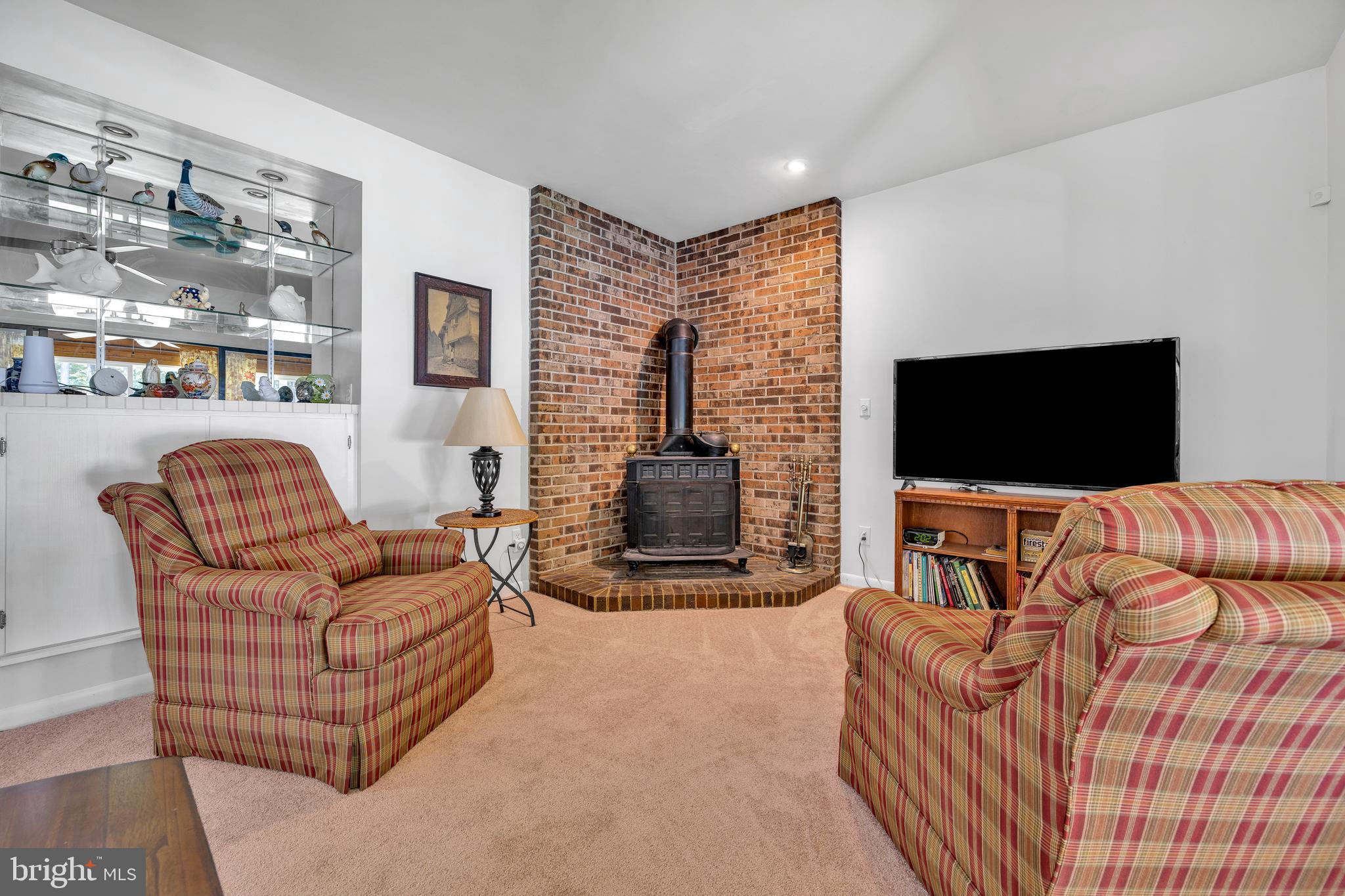 292 Pond Road Millsboro, DE 19966 - Photo 15 of 66 a living room with furniture and a flat screen tv