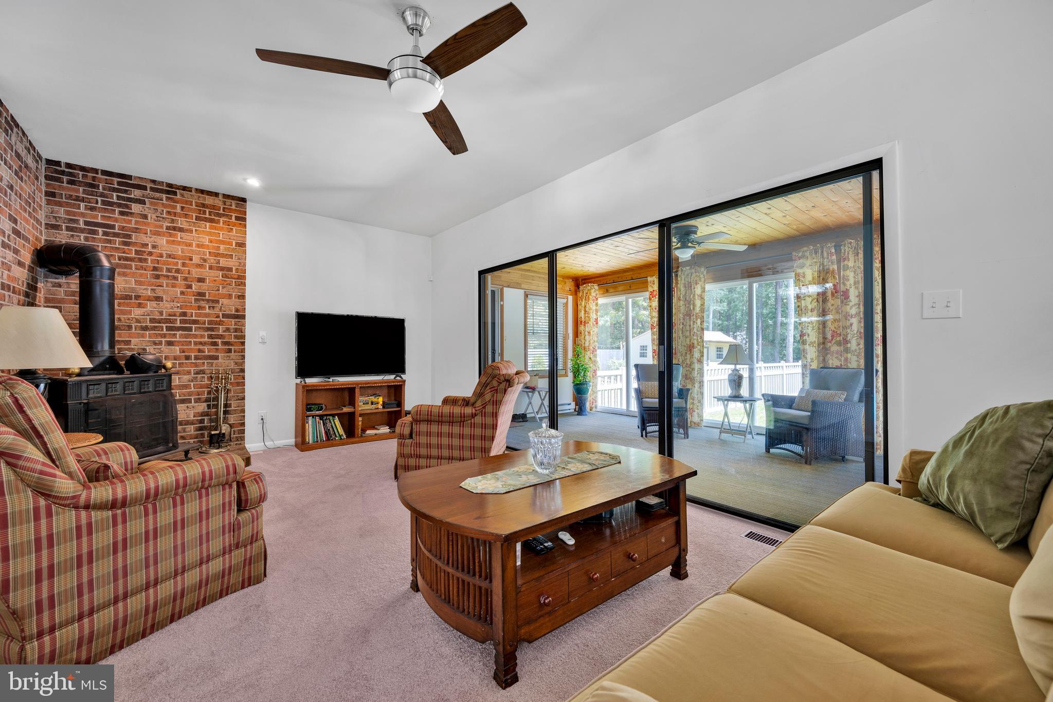 292 Pond Road Millsboro, DE 19966 - Photo 16 of 66 a living room with furniture and a flat screen tv